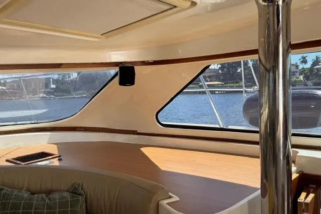 Slide: The Image of Interior view of 2007 Africat Marine 420 yacht with large windows and seating area. - 44