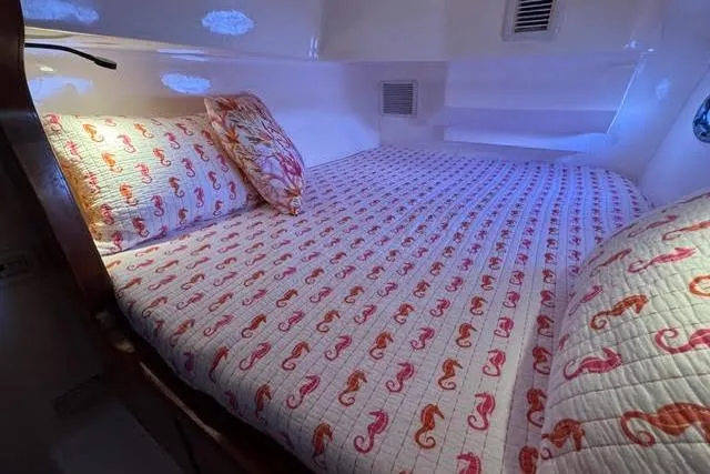Slide: The Image of Cozy cabin bed with seahorse-patterned bedding in 2007 Africat Marine 420 yacht. - 48