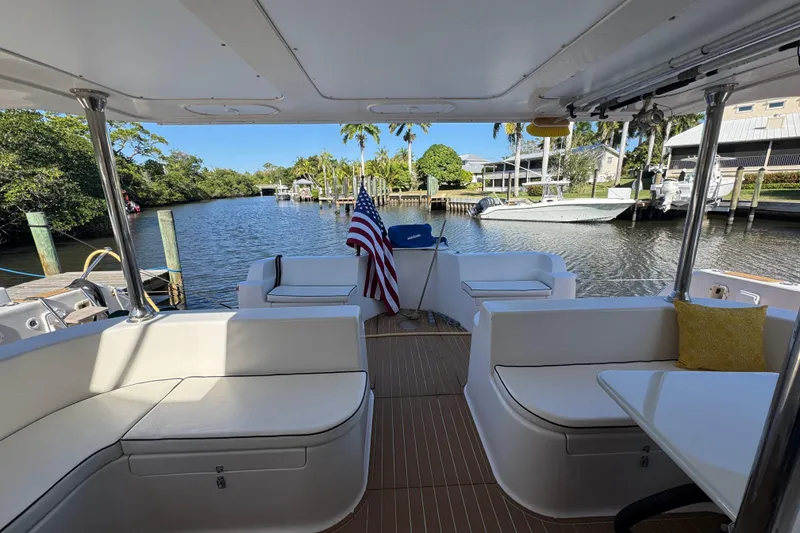 Slide: The Image of Luxurious 2007 Africat Marine 420 yacht interior with seating, table, and American flag. - 5