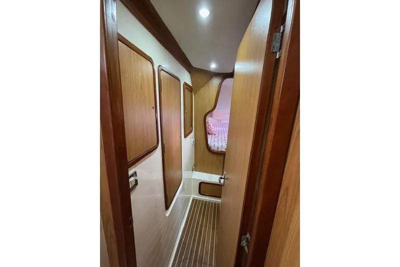 Slide: The Image of 2007 Africat Marine 420 yacht interior hallway with wood paneling and cozy cabin view. - 50