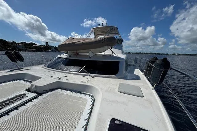 Slide: The Image of 2007 Africat Marine 420 yacht on open water under a clear blue sky. - 54