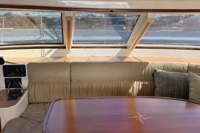 Slide: The Image of Interior of 2007 Africat Marine 420 yacht with leather seating and wooden table. - 56