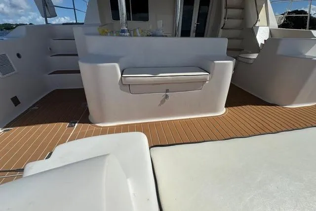 Slide: The Image of 2007 Africat Marine 420 yacht deck with seating and steps, featuring teak flooring. - 59