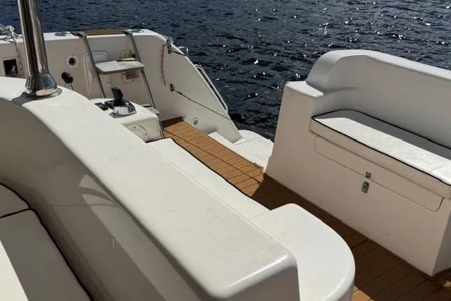 Slide: The Image of 2007 Africat Marine 420 yacht deck with white seating and wooden flooring. - 6