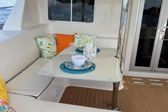 Slide: The Image of Cozy dining area on 2007 Africat Marine 420 yacht with colorful cushions and tableware. - 62