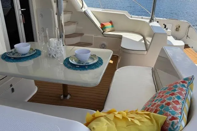 Slide: The Image of Luxurious 2007 Africat Marine 420 yacht interior with elegant dining setup and colorful cushions. - 63