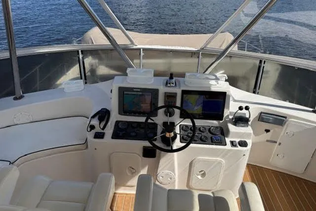 Slide: The Image of Helm of 2007 Africat Marine 420 yacht with navigation equipment and seating, overlooking water. - 66