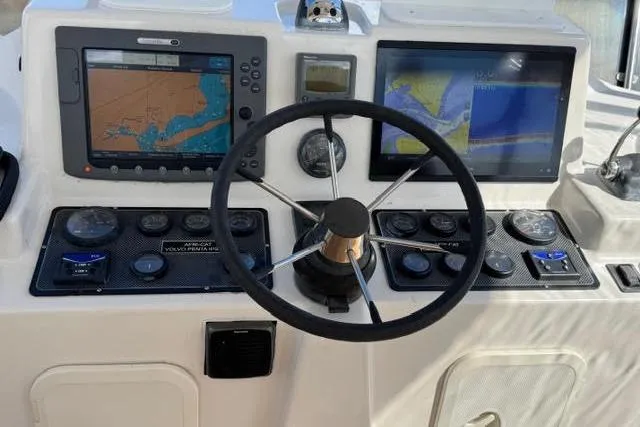 Slide: The Image of Steering console of 2007 Africat Marine 420 with navigation screens and controls. - 68