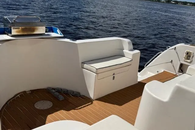 Slide: The Image of 2007 Africat Marine 420 boat deck with seating and grill, overlooking calm waters. - 7