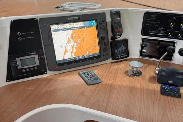 Slide: The Image of Control panel of a 2007 Africat Marine 420 with navigation and communication equipment. - 76