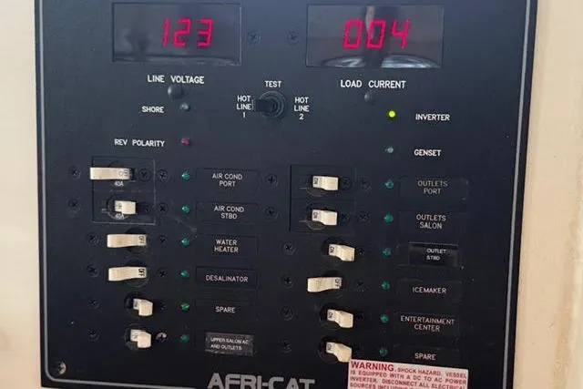 Slide: The Image of Electrical control panel on a 2007 Africat Marine 420 boat, displaying voltage and current. - 77