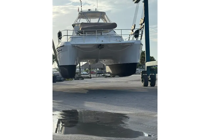Slide: The Image of 2007 Africat Marine 420 catamaran lifted on a dock, with a reflection in a puddle. - 81