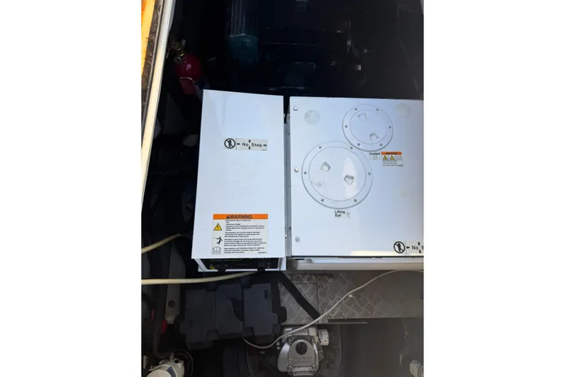 Slide: The Image of Engine compartment of a 2007 Africat Marine 420 boat, featuring warning labels. - 83