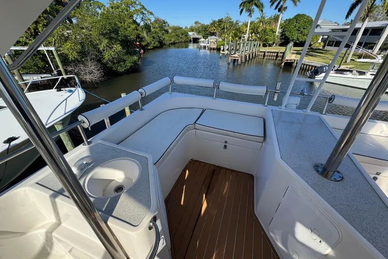 Slide: The Image of 2007 Africat Marine 420 yacht deck with seating and sink, overlooking a serene waterway. - 84