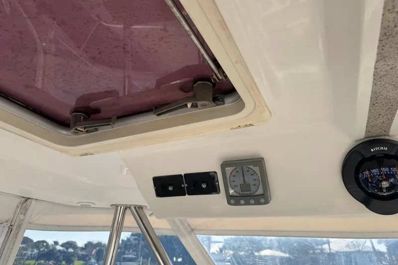 Slide: The Image of Interior view of a 2007 Africat Marine 420 boat, featuring a hatch and navigation instruments. - 86