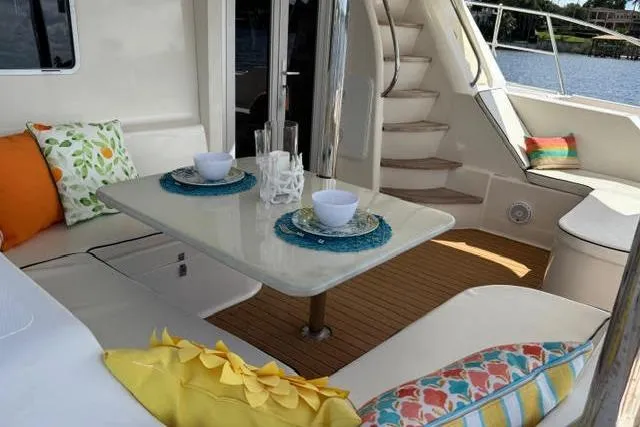 Slide: The Image of Luxurious 2007 Africat Marine 420 yacht interior with cozy seating and elegant dining setup. - 9