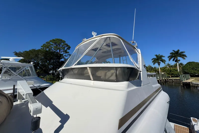 Slide: The Image of 2007 Africat Marine 420 yacht docked, clear sky, palm trees in background. - 93