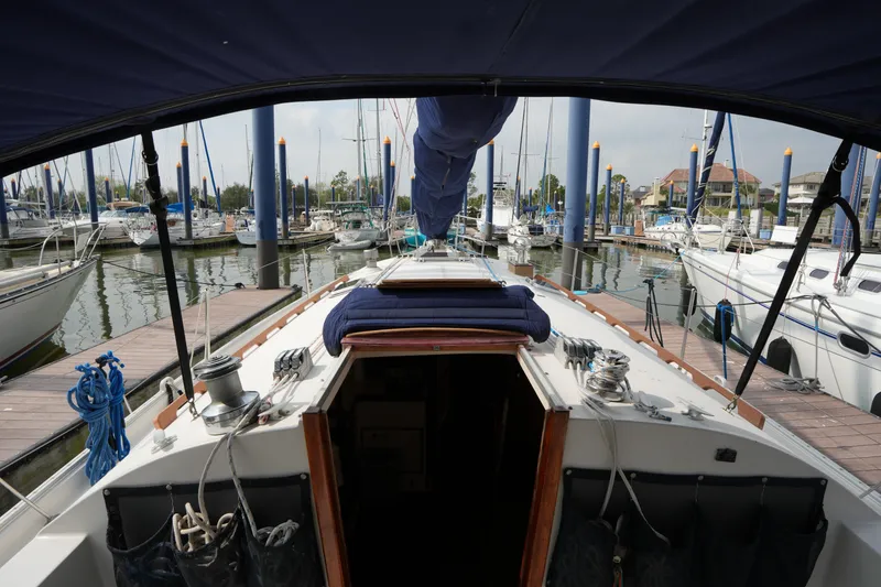 Slide: The Image of 1988 Nonsuch 30 Ultra sailboat docked in a marina, view from the cockpit. - 10