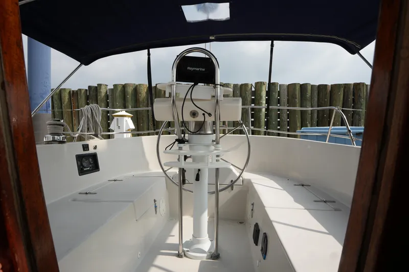 Slide: The Image of 1988 Nonsuch 30 Ultra sailboat cockpit with steering wheel and navigation equipment. - 11