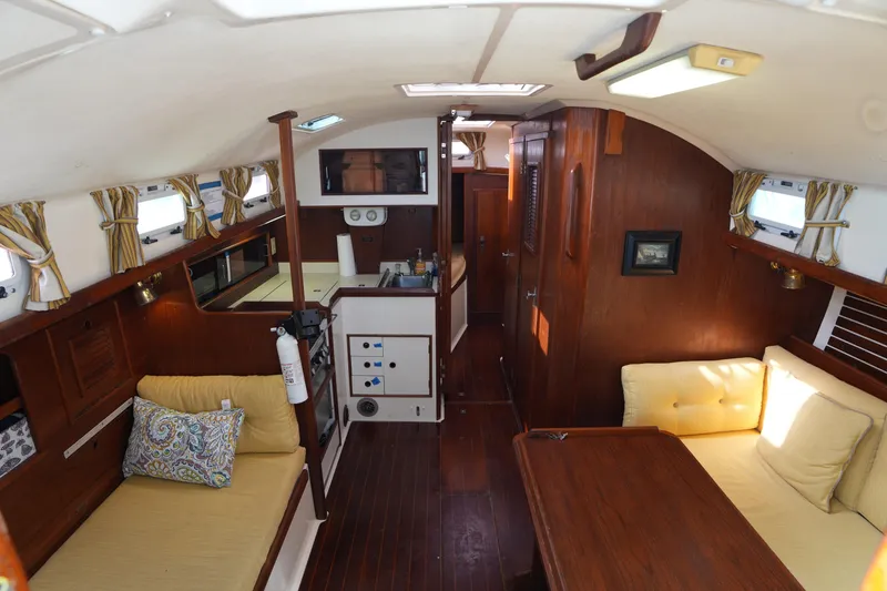 Slide: The Image of Interior of 1988 Nonsuch 30 Ultra sailboat with cozy seating and wooden finishes. - 12
