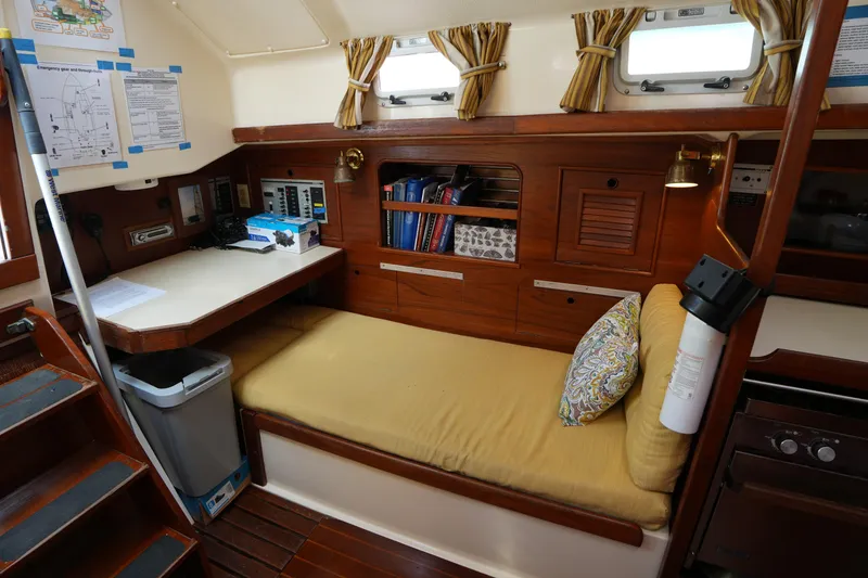 Slide: The Image of Cozy interior of 1988 Nonsuch 30 Ultra sailboat with wooden furnishings and navigation station. - 14