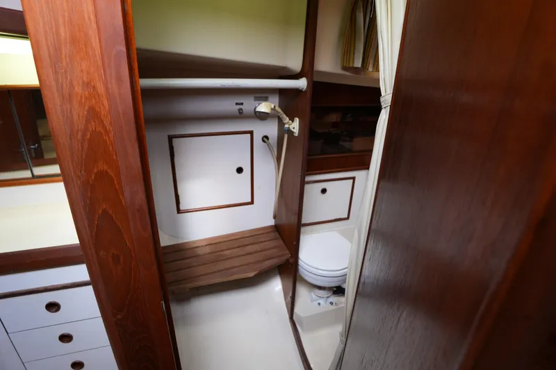Slide: The Image of 1988 Nonsuch 30 Ultra yacht interior bathroom with wooden cabinetry and compact design. - 19