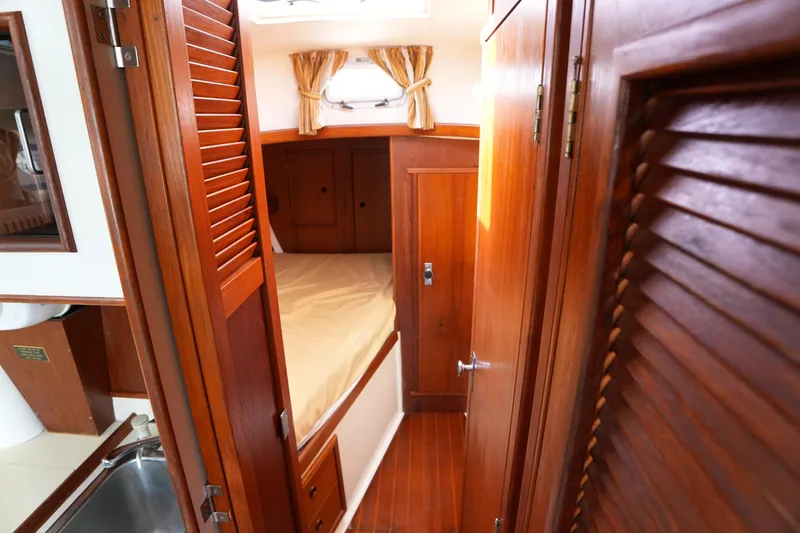 Slide: The Image of 1988 Nonsuch 30 Ultra cabin interior with wooden finish and cozy sleeping area. - 20