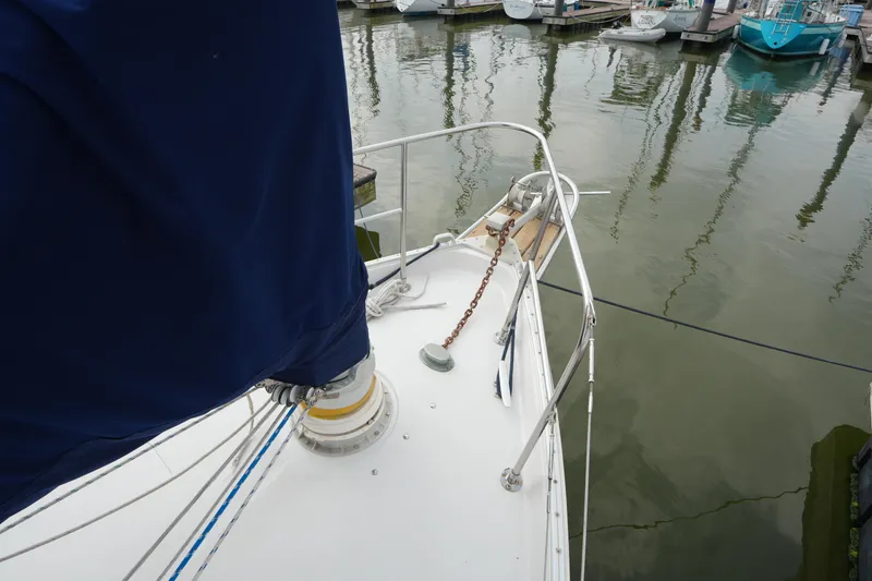 Slide: The Image of 1988 Nonsuch 30 Ultra sailboat bow with anchor chain in marina. - 5