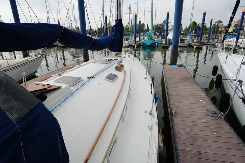 Slide: The Image of 1988 Nonsuch 30 Ultra sailboat docked at marina with blue sail cover. - 6