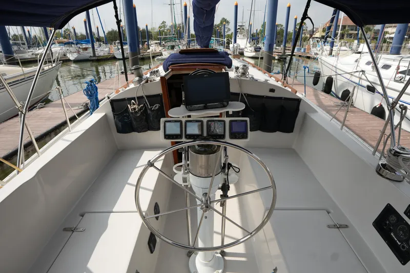 Slide: The Image of Cockpit of 1988 Nonsuch 30 Ultra sailboat with navigation equipment and marina view. - 8