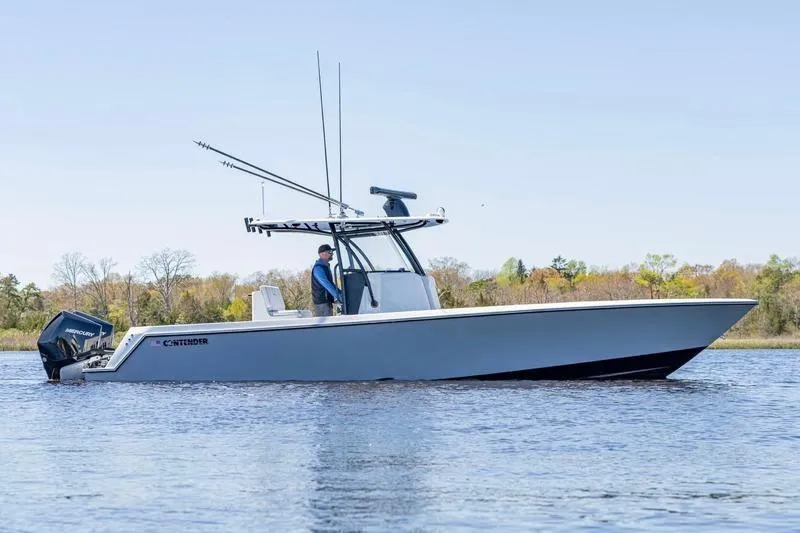 The Image of 2022 Contender 32 ST boat on calm water, featuring sleek design and powerful outboard engines. - 0