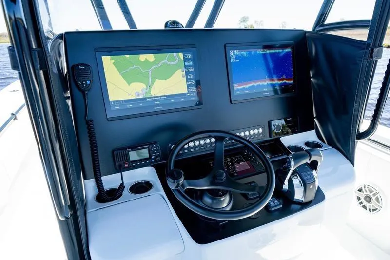 Slide: The Image of 2022 Contender 32 ST boat dashboard with navigation screens and controls. - 13