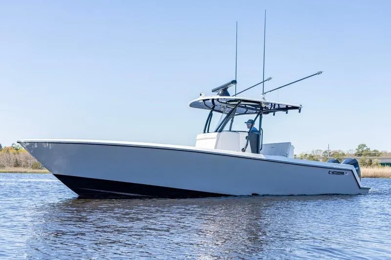 Slide: The Image of 2022 Contender 32 ST boat on calm water, side view. - 4