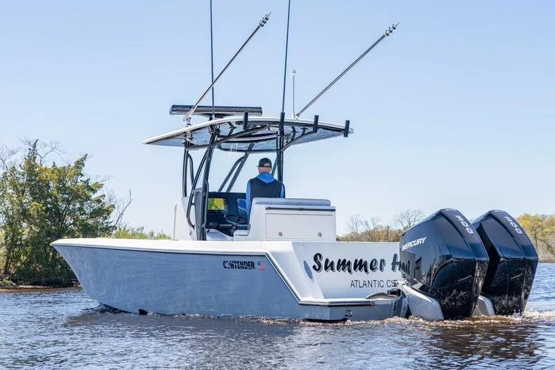 Slide: The Image of 2022 Contender 32 ST boat with dual Mercury engines on a calm waterway. - 5