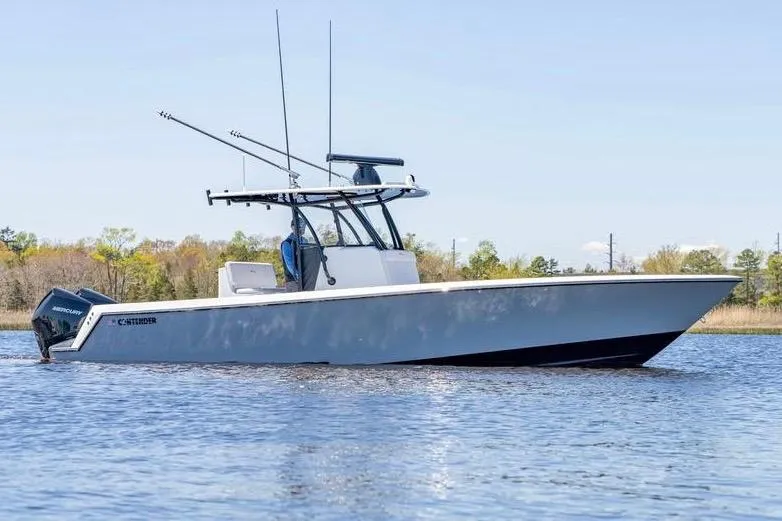 Slide: The Image of 2022 Contender 32 ST boat on calm water, featuring sleek design and powerful engines. - 9