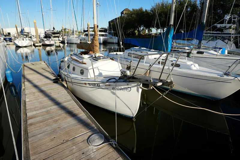 The Image of 1982 Pacific Seacraft Flicka 20 sailboat docked at a marina, surrounded by other boats. - 1