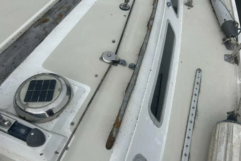 Slide: The Image of 1985 Catalina 36 sailboat deck with solar vent and fittings. - 10