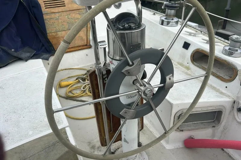 Slide: The Image of Steering wheel of a 1985 Catalina 36 sailboat, featuring nautical equipment and ropes. - 14