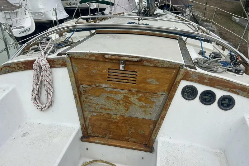 Slide: The Image of 1985 Catalina 36 sailboat cockpit with weathered wood and nautical equipment. - 20