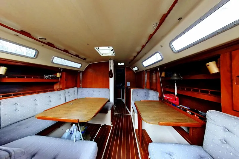 Slide: The Image of Interior of a 1985 Catalina 36 sailboat with wooden furnishings and cozy seating. - 22