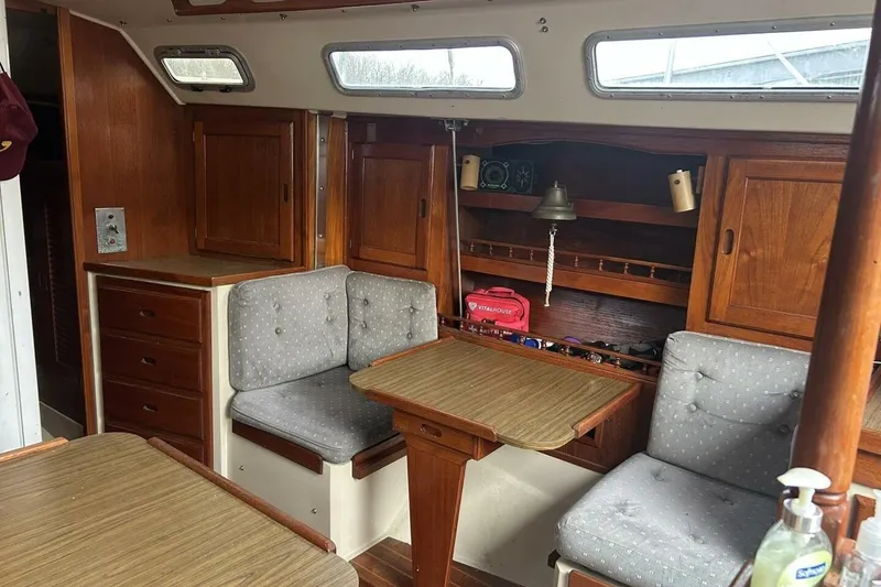 Slide: The Image of Interior of 1985 Catalina 36 sailboat with wooden cabinetry and cushioned seating. - 25
