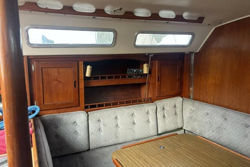 Slide: The Image of Interior of 1985 Catalina 36 sailboat with wood cabinets and cushioned seating. - 26