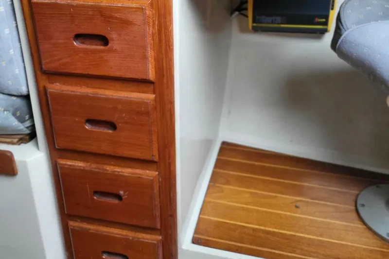 Slide: The Image of Interior of 1985 Catalina 36 sailboat with wooden drawers and seating area. - 28