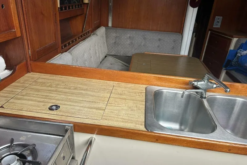 Slide: The Image of Interior of 1985 Catalina 36 sailboat featuring kitchen sink and dining area. - 34