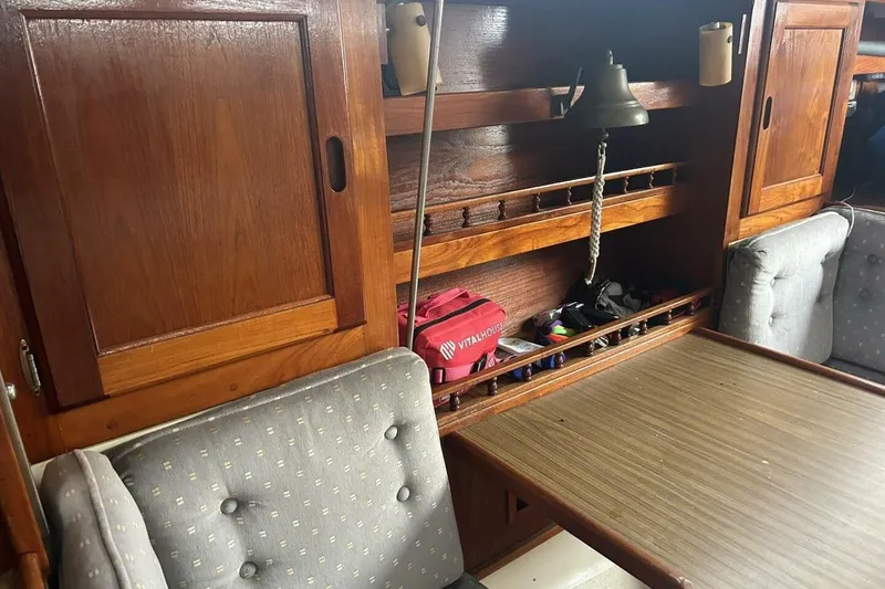 Slide: The Image of Interior of 1985 Catalina 36 sailboat with wooden cabinets and seating area. - 36
