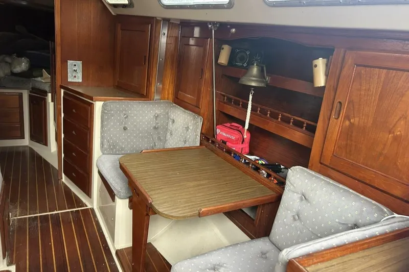 Slide: The Image of Interior of a 1985 Catalina 36 sailboat with wooden cabinetry and cushioned seating. - 38