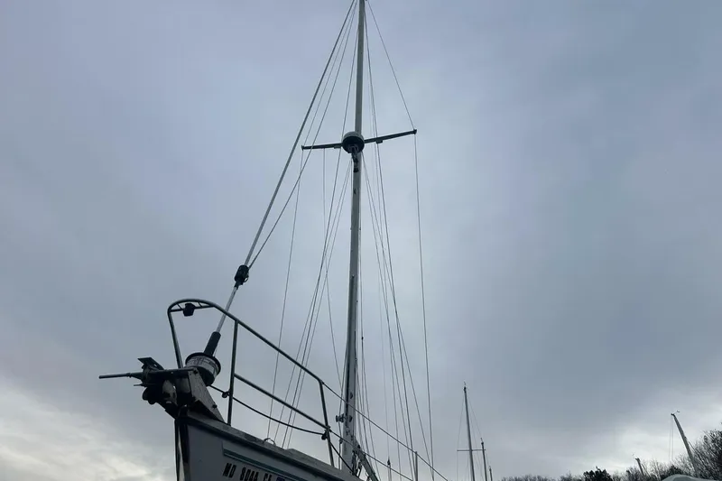 Slide: The Image of 1985 Catalina 36 sailboat with tall mast against cloudy sky. - 4