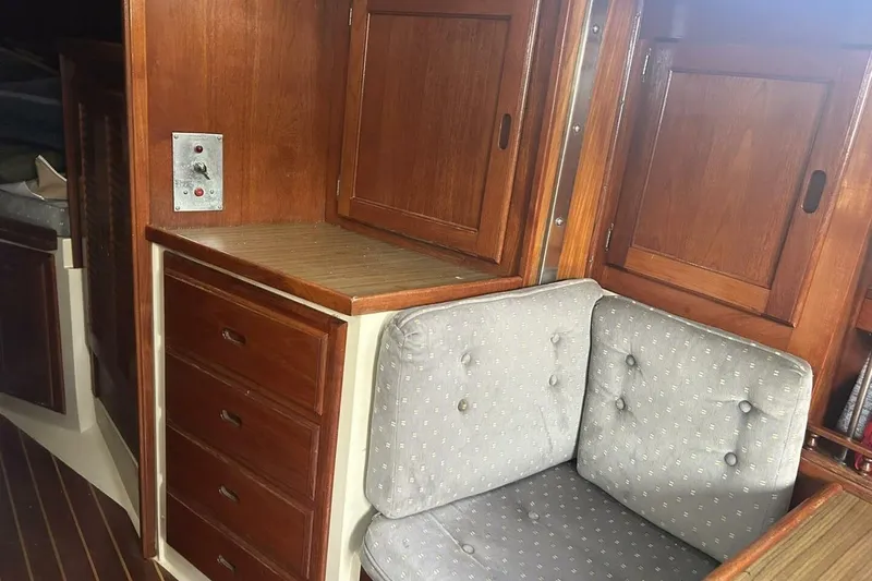 Slide: The Image of 1985 Catalina 36 yacht interior with wooden cabinets and cushioned seating. - 41