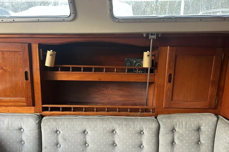 Slide: The Image of Interior of 1985 Catalina 36 sailboat with wooden cabinets and cushioned seating. - 42
