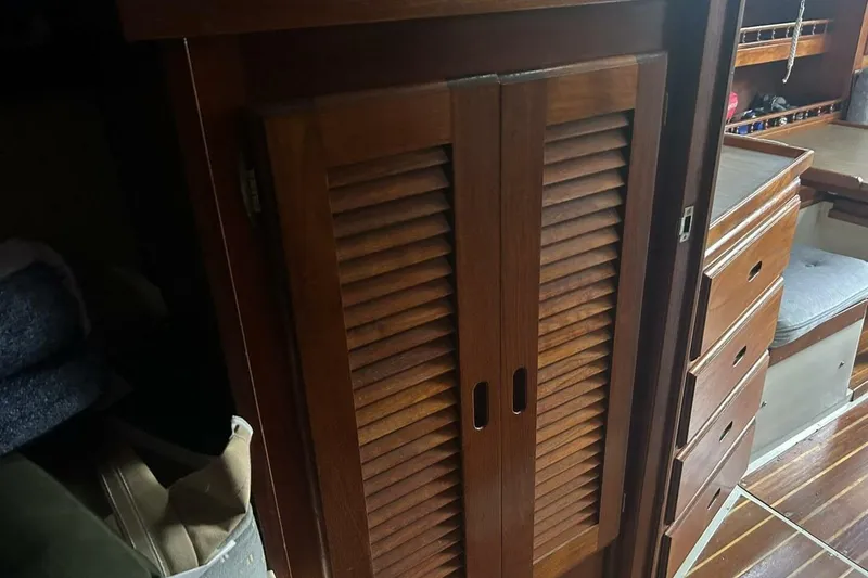 Slide: The Image of Interior of 1985 Catalina 36 sailboat featuring wooden cabinets and drawers. - 44